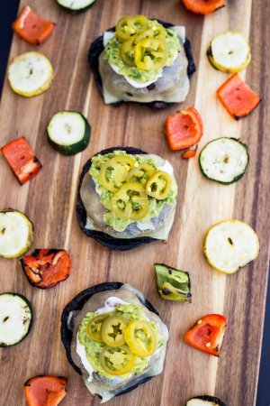 Photo for A vertical shot of burger sliders with pickled jalapenos and grilled veggies on a wooden table - Royalty Free Image