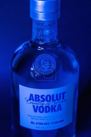 Photo for A vertical shot of a Limited edition Absolut Vodka bottle with blue lights shining on it - Royalty Free Image