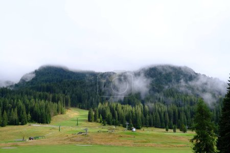 Photo for A beautiful shot of clouds floating over mountains and valleys in Madonna di Campiglio, Italy - Royalty Free Image