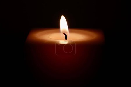 Photo for A macro shot of a candle's flame in the darkness, the concept of a hope in the most difficult times - Royalty Free Image