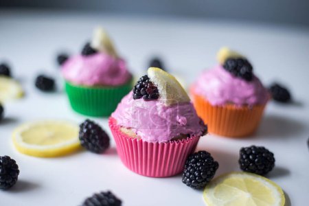 Photo for A closeup of purple cupcakes with blackberries - Royalty Free Image
