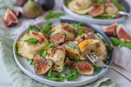 Photo for A high-angle view of pumpkin tortellini with fresh figs and herbs dressing - Royalty Free Image