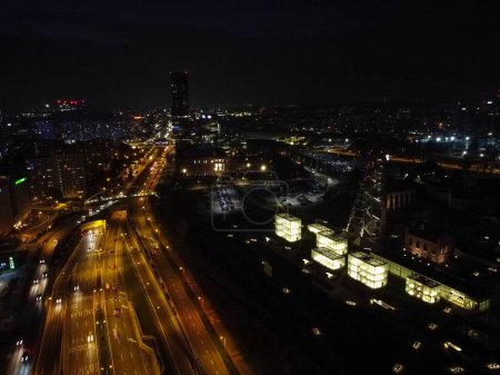 Photo for An aerial shot of roads in the middle of city buildings at night in Katowice, Poland - Royalty Free Image