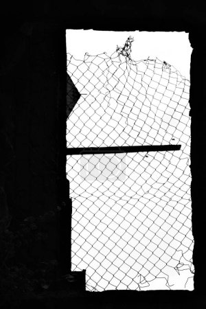 Photo for A vertical of a crooked mesh fence on a window shot in grayscale - Royalty Free Image