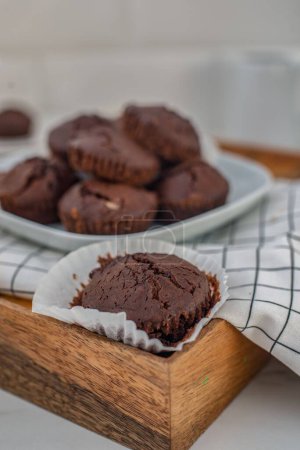 Photo for A Closeup of baked chocolate muffins in white plate - Royalty Free Image