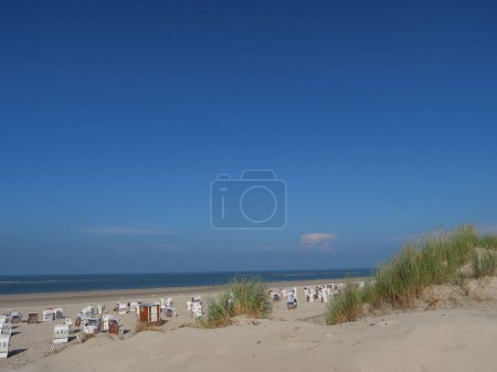 Téléchargez les photos : Un paysage de cabanes à la plage entouré de verdure à Spiekeroog, Allemagne - en image libre de droit