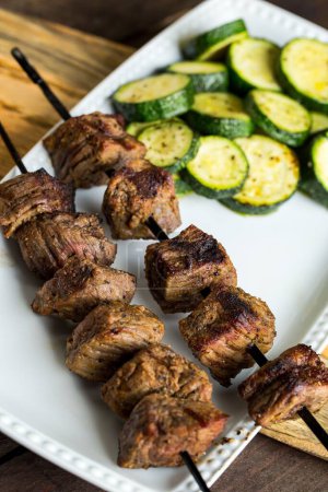 Photo for A Closeup of a Steak Shish Kababb with a barbecued zucchini side dish - Royalty Free Image