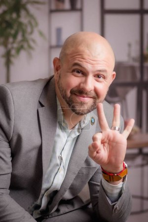 Photo for A closeup portrait of a happy man showing an okay sign with a hand - Royalty Free Image