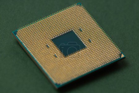 Photo for A processor for a computer lies on an isolated green background - Royalty Free Image