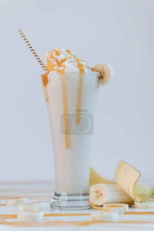 Photo for A vertical shot of a banana shake on the white background - Royalty Free Image