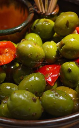 Photo for A vertical closeup of aceitunas, green olives shining from having an oily surface - Royalty Free Image