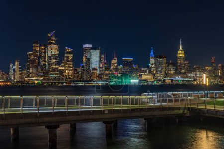 Photo for An amazing view of the New York City Manhattan skyline illuminated with lights - Royalty Free Image