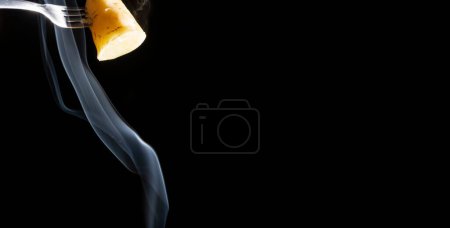 Photo for A closeup of sweet potato skewered on a fork receiving white smoke from below - Royalty Free Image