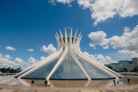 The facade of The Cathedral of Brasilia against a blue cloudy sky in Brasilia, Brazil