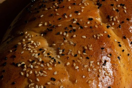 Photo for A closeup shot of freshly baked brioche sprinkled with nigella and sesame seeds - Royalty Free Image