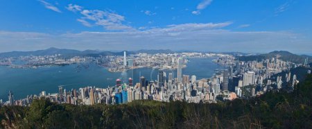 Photo for A panoramic shot of the Hong Kong surrounded buy the mountains and the sea under the blue sky - Royalty Free Image