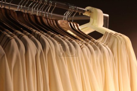 Photo for A row of similar clothes hanging on a rack - performance concept - Royalty Free Image
