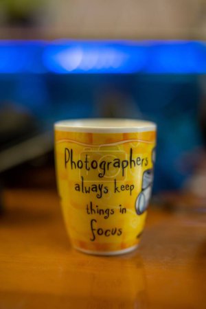 Photo for A vertical shot of a tea mug with a text isolated on a blurred background - Royalty Free Image