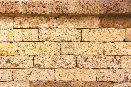 Photo for A closeup of a rough sandstone bricks surface with pores - Royalty Free Image