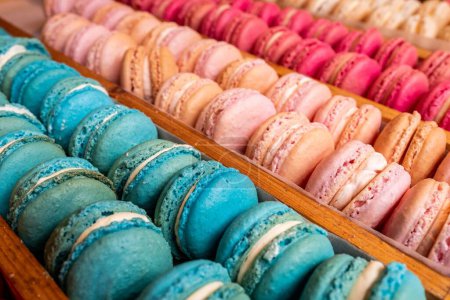 Photo for A high-angle view of trays of colorful macarons displayed on a wooden stand - Royalty Free Image