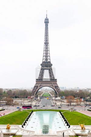 Photo for A vertical view of the Eiffel Tower from the Trocadero gardens on a cloudy day in Paris, France - Royalty Free Image