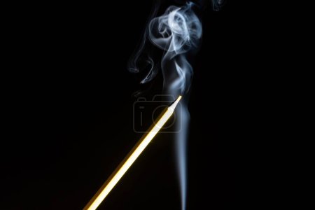 Photo for A closeup of colorful pencil and white smoke on a black background - Royalty Free Image