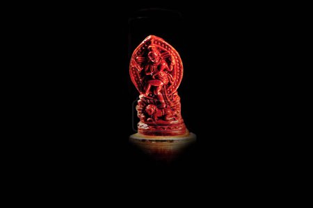 Photo for A brownish-red miniature religious idol on black background - Royalty Free Image