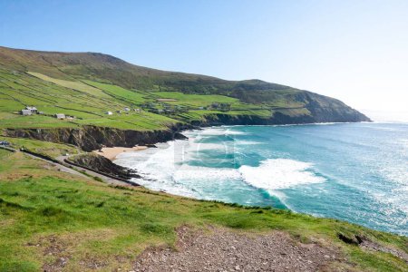 A beautiful view of the Coumeenoole Beach under a blue sky in County Kerry, Ireland