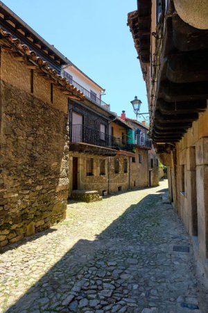 Photo for A vertical shot of a narrow alley with cobblestone ground and traditional buildings in La Alberca - Royalty Free Image