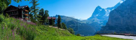 Photo for A panoramic shot of the house on top of the hill with mountains and trees in the background - Royalty Free Image
