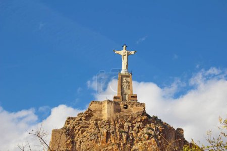 Foto de La estatua de Jesús y el castillo de Castillo de Monteagudo en España contra el cielo azul - Imagen libre de derechos