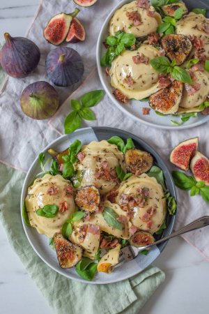 Photo for A top vertical view of pumpkin tortellini dished with fresh figs and herbs dressing - Royalty Free Image
