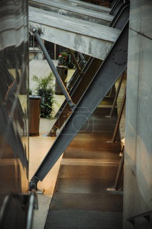 Photo for Outdoor metal stairs under a metal bridge with modern stone hall - Royalty Free Image