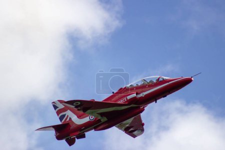 Photo for A red aircraft during the Cosford Air show in the blue sky - Royalty Free Image