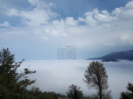 Téléchargez les photos : Une vue aérienne depuis des montagnes d'épaisse couche de brouillard et de nuages au-dessus - en image libre de droit