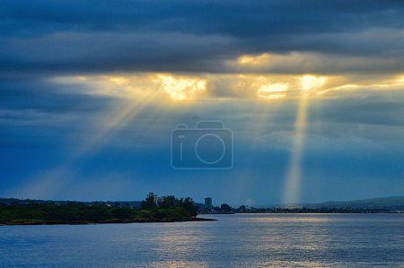 Photo for The sunset at the bay of Matanzas, Cuba, the slanting rays shining through clouds and the skyline - Royalty Free Image