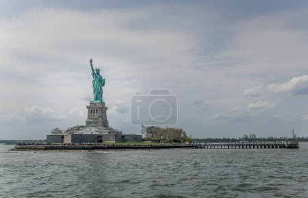 Photo for A magnificent view of the colossal neoclassical sculpture Statue of Liberty,  on the Hudson river - Royalty Free Image