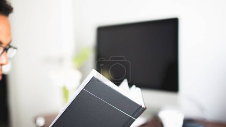 Photo for A closeup shot of a man looking at his work schedule in front of computer - Royalty Free Image