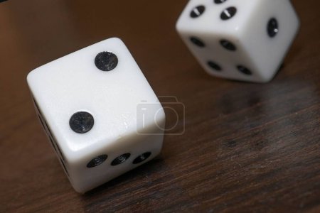 Photo for A closeup shot of gambling dice on a wooden table - Royalty Free Image