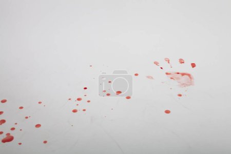Photo for The bloody trails of hands and dripped blood on the white ground. - Royalty Free Image