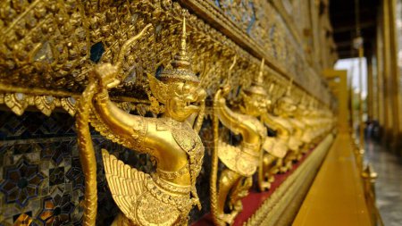 Photo for A selective focus shot of golden garuda statues inside  Temple of the Emerald Buddha in Thailand - Royalty Free Image