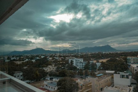 Photo for A scenic shot of the buildings in cloudy Coimbatore city in India with mountains on the background - Royalty Free Image