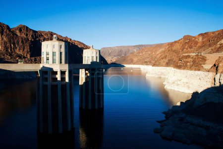Photo for An aerial shot of the Hoover Dam and Lake Mead in Nevada surrounded by big mountains on a sunny day - Royalty Free Image
