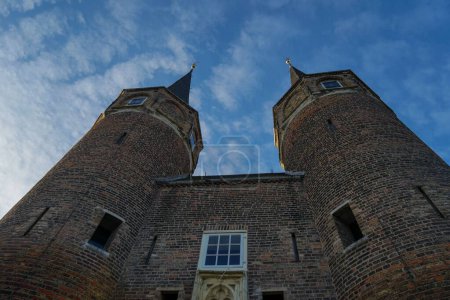 Téléchargez les photos : Un plan à faible angle de l'Oospoort sous les nuages à Delft, Pays-Bas - en image libre de droit