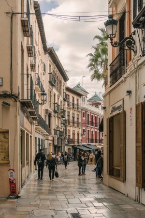 Photo for A vertical shot of people enjoying their city life by walking in Granada, Spain - Royalty Free Image