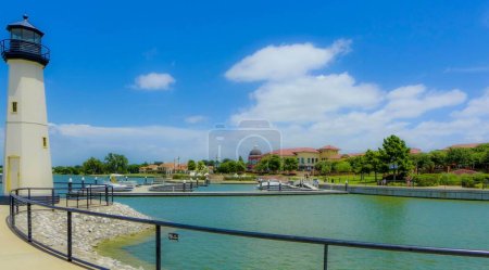 Photo for The fenced Rockwall Lake with the lighthouse and trees on its coasts before the blue sky - Royalty Free Image