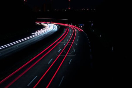 Photo for A landscape of a highway with long exposure car headlights at night - great for backgrounds - Royalty Free Image