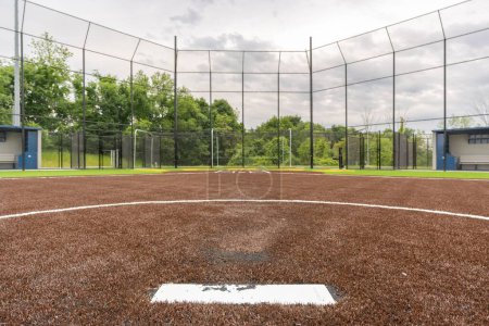 Photo for View of high school synthetic turf softball field pitching rubber looking toward home plate. - Royalty Free Image