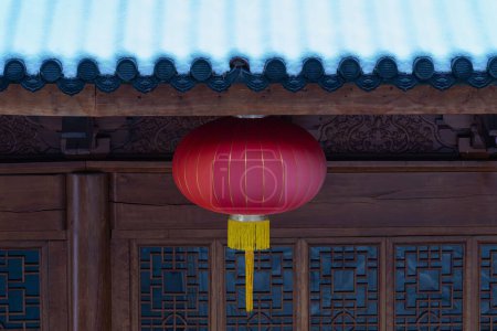 Photo for A red Asian lamp hanging from snowy roof - Royalty Free Image