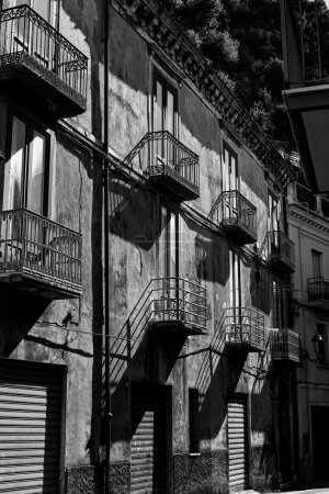 Photo for A vertical grayscale of apartment balconies of a residential building in Lauria, southern Italy - Royalty Free Image